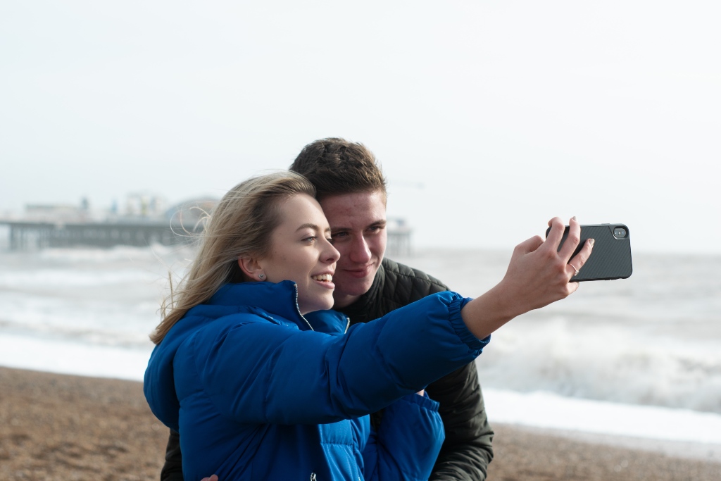 Couple taking a selfie with a mobile phone on a beach